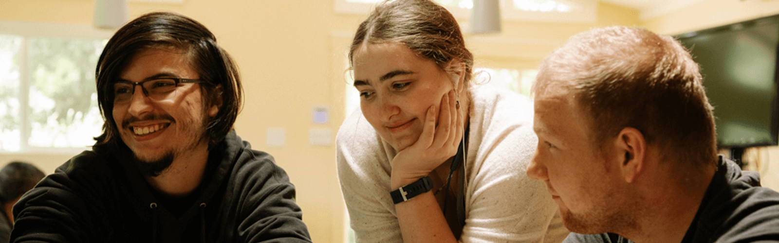 A student with advisors from Meristem's independent living programs for young adults with autism