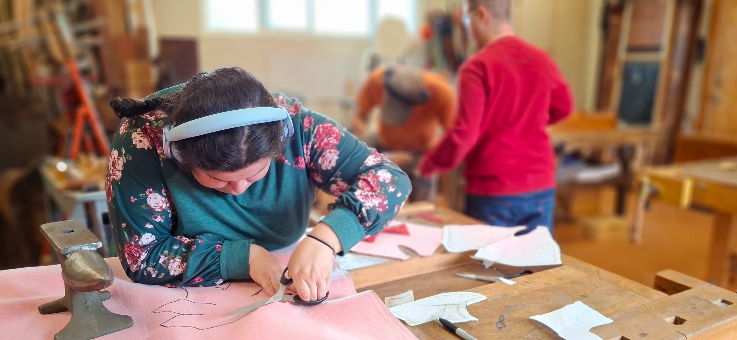 student cutting out a pattern in a textile course at Meristem