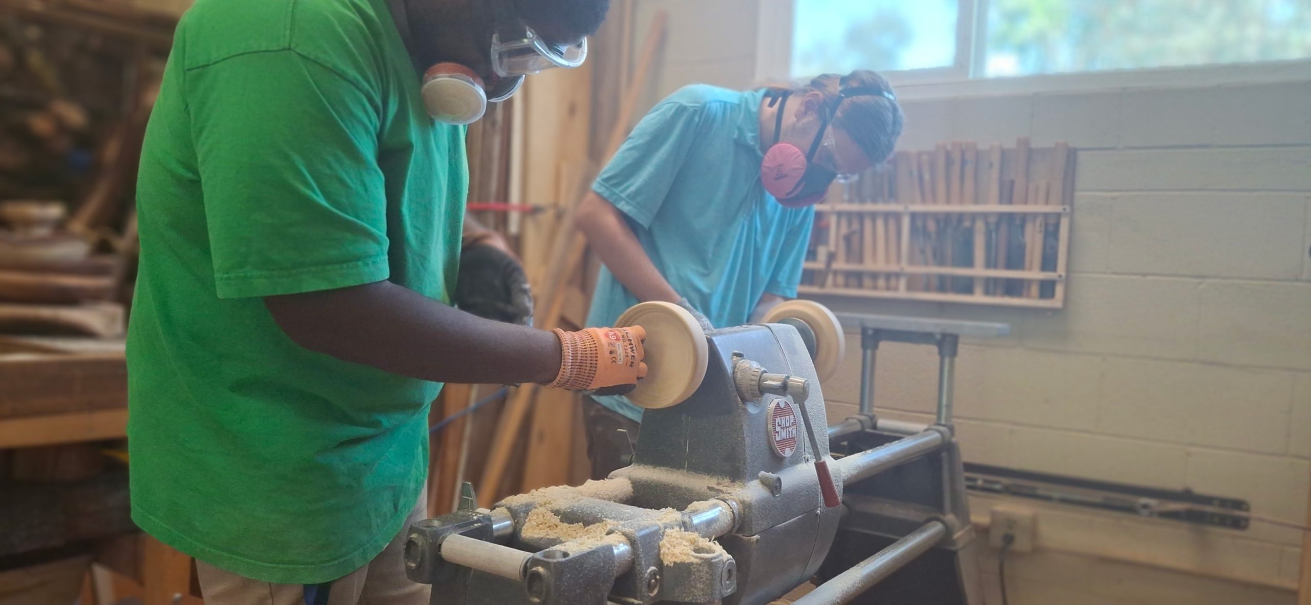 Meristem student working on a wooden bowl